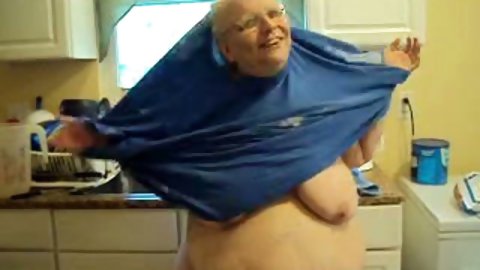 Watch this nightmarish old whore, man! This experienced harlot is my neighbour. She takes off her clothes to show her saggy boobs and cellulite ass.